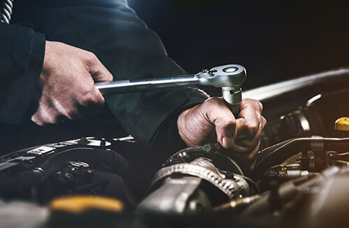 Technician Working on Engine